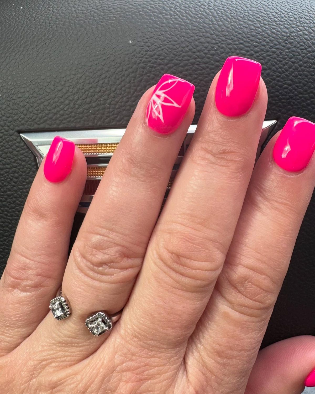 Bright pink manicure with white line detail done at Phong Beauty Salon